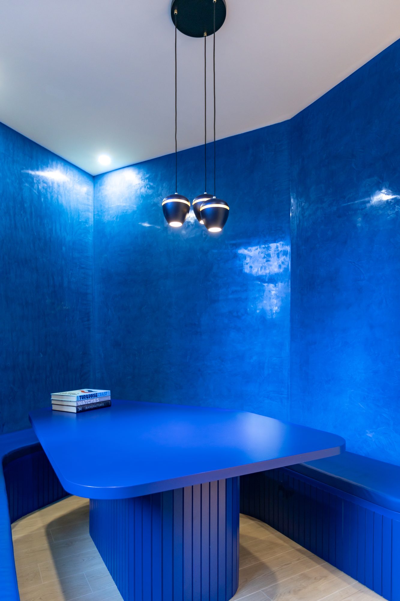 Brugmann 421 — Cabine de réunion — table bleu cobalt monobloc, banquettes encastrées